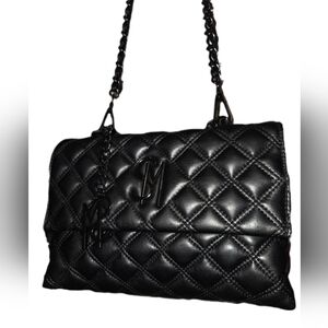 The black quilted Steve Madden Crossbody With SM CHARM